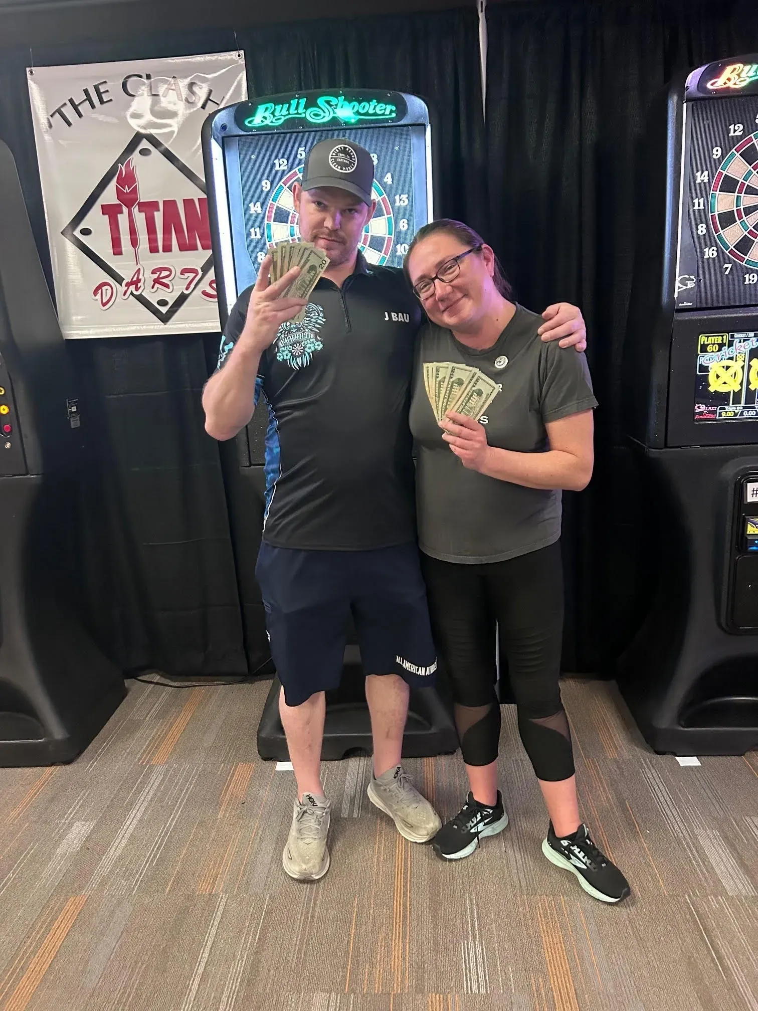 Couple celebrating win at dart tournament