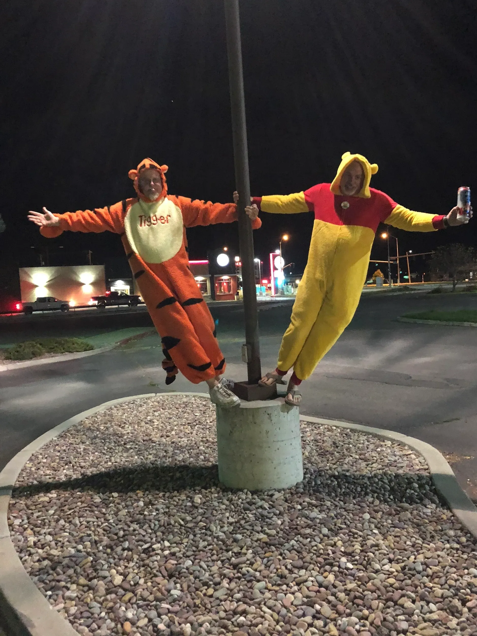 People in Tigger and Pooh costumes balancing