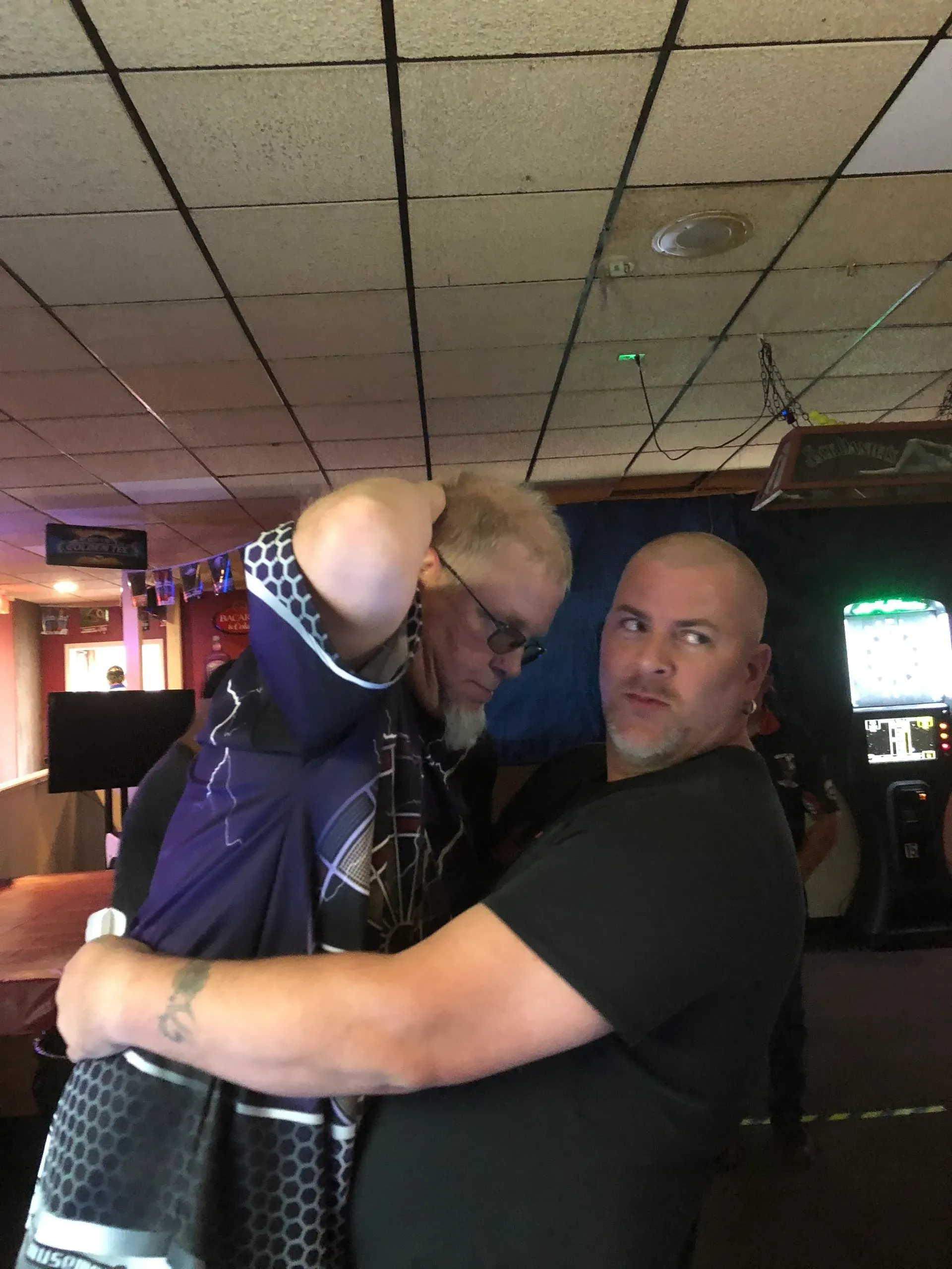 Friends embracing in a casual setting.