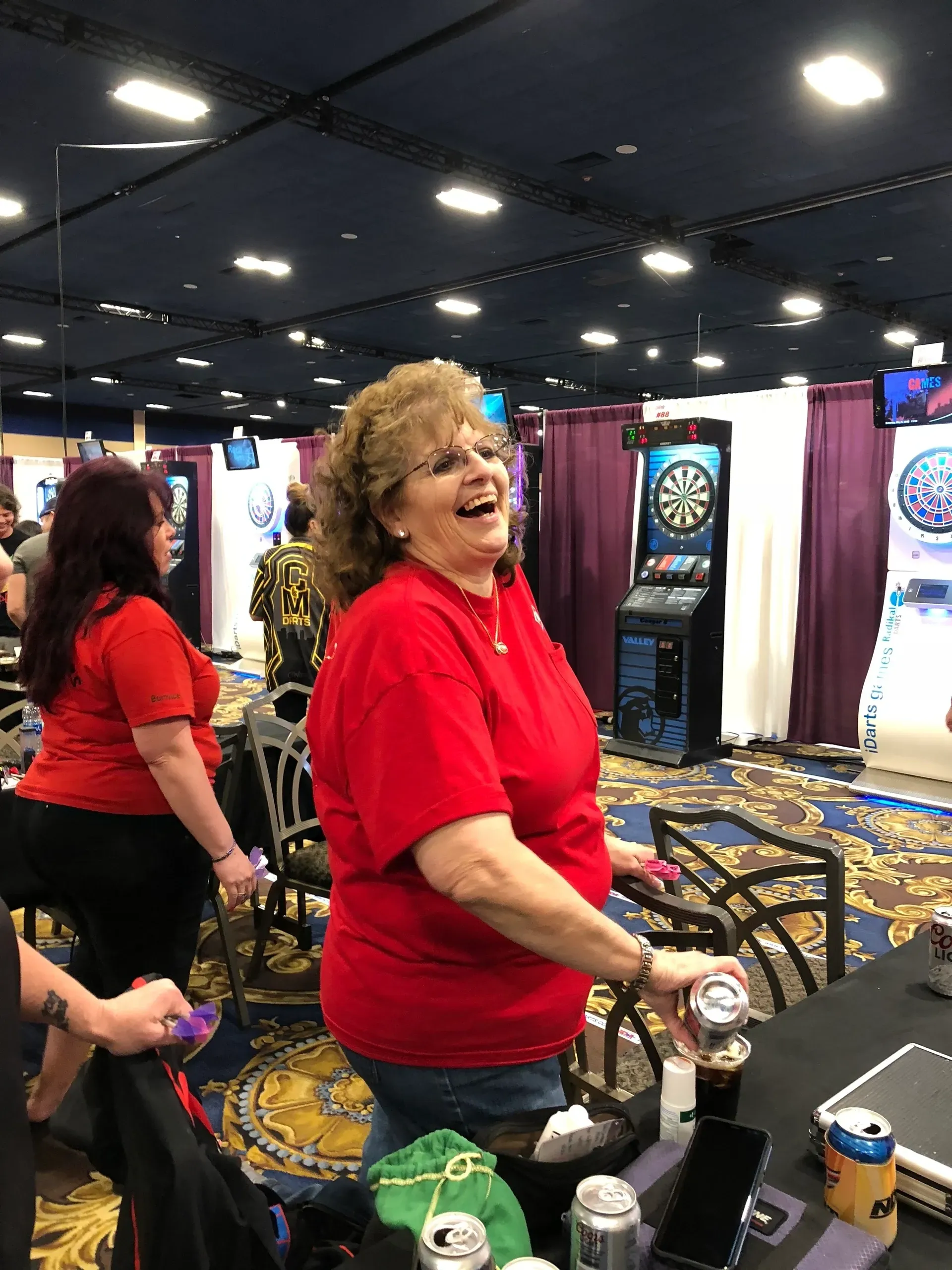 Laughter at indoor darts competition