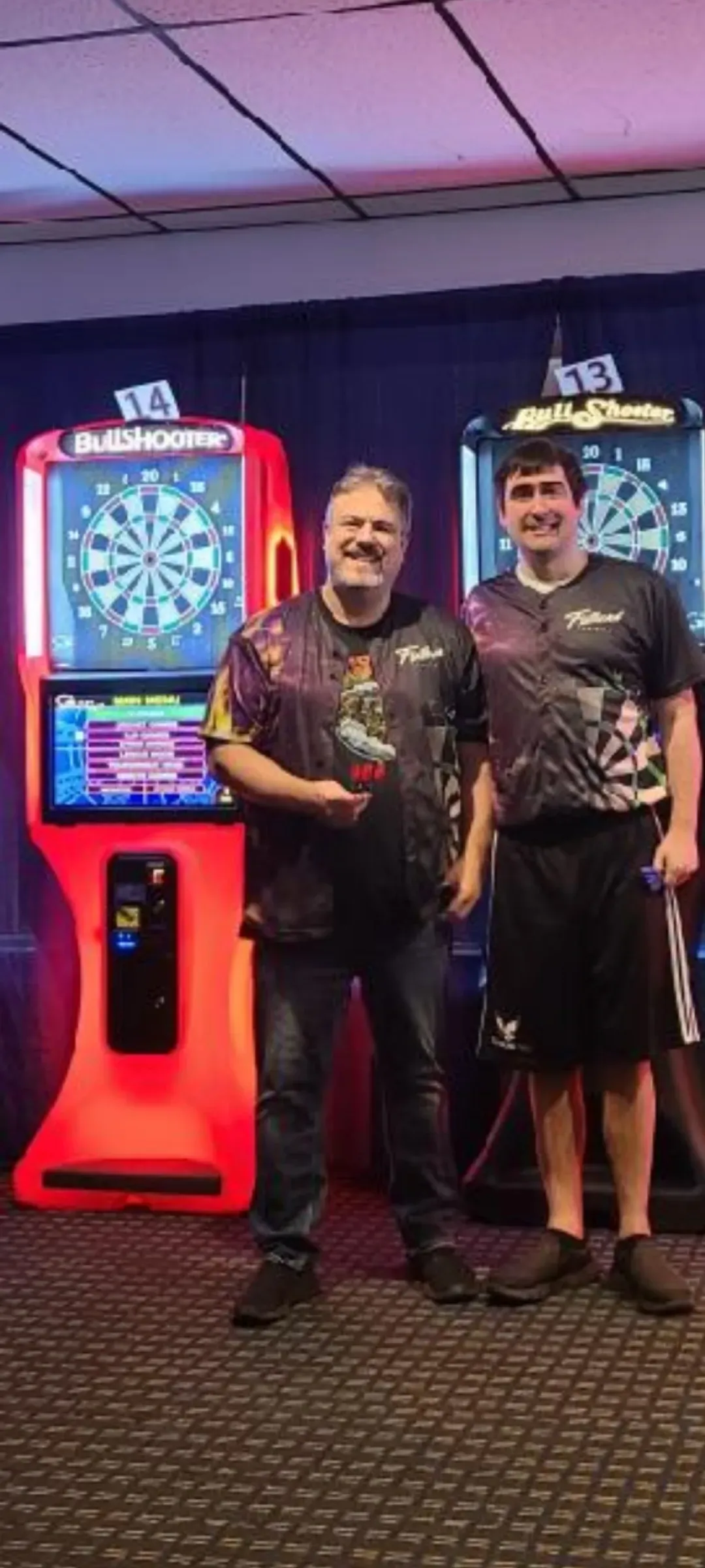 Smiling duo at dart tournament venue