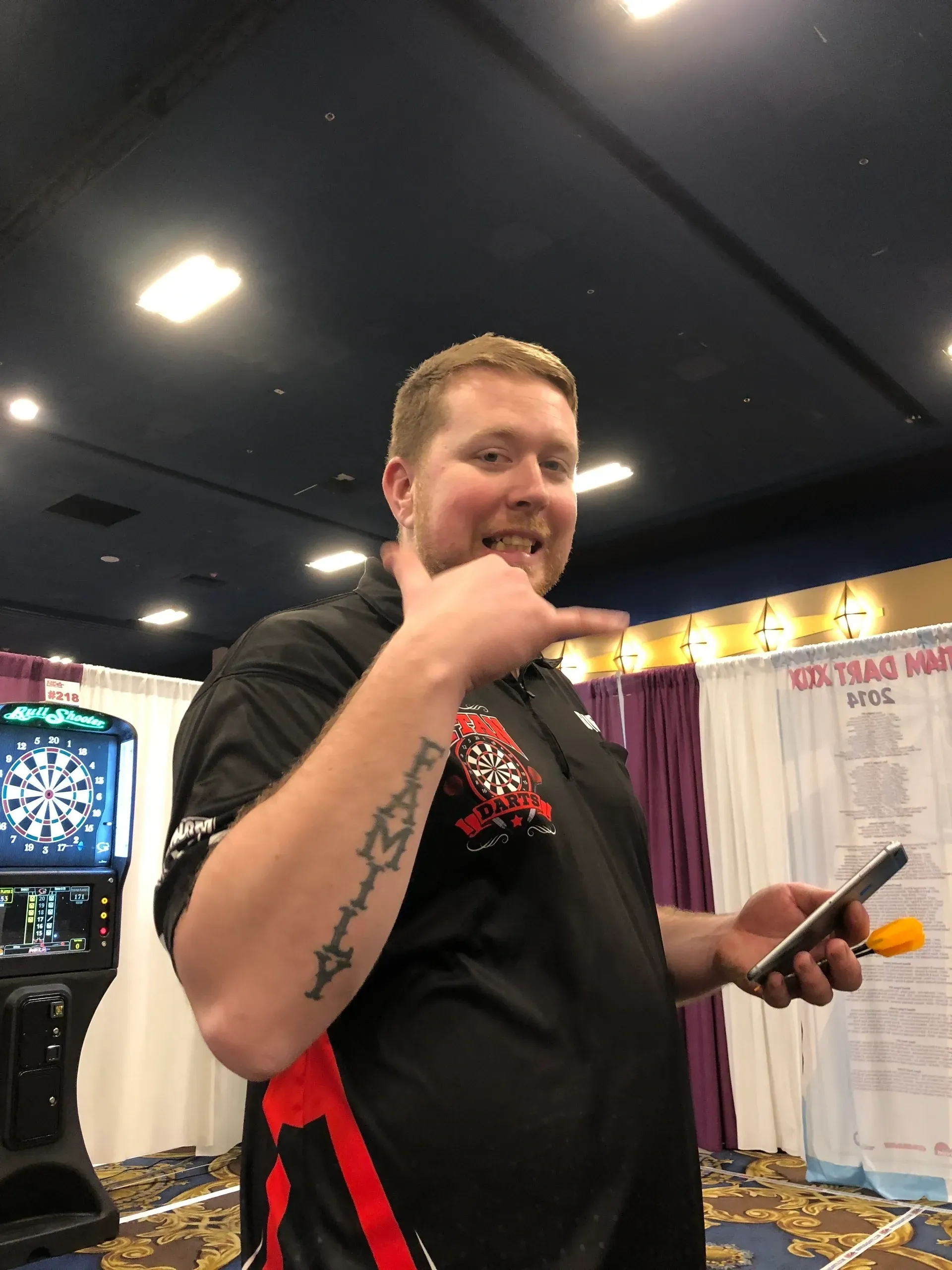 Individual gesturing happily indoors