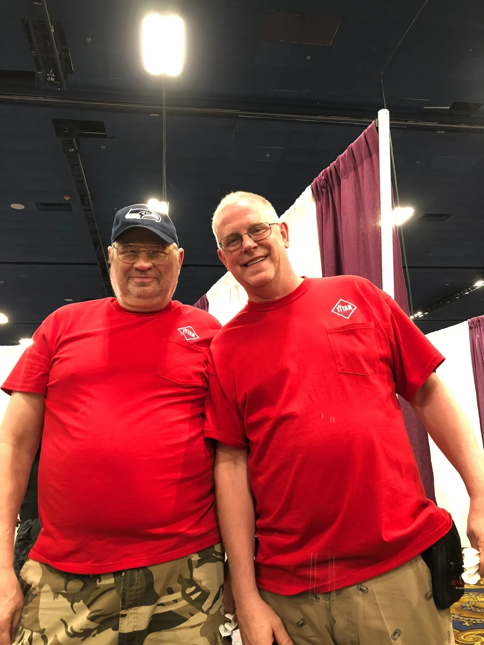 Friends posing indoors, wearing red shirts