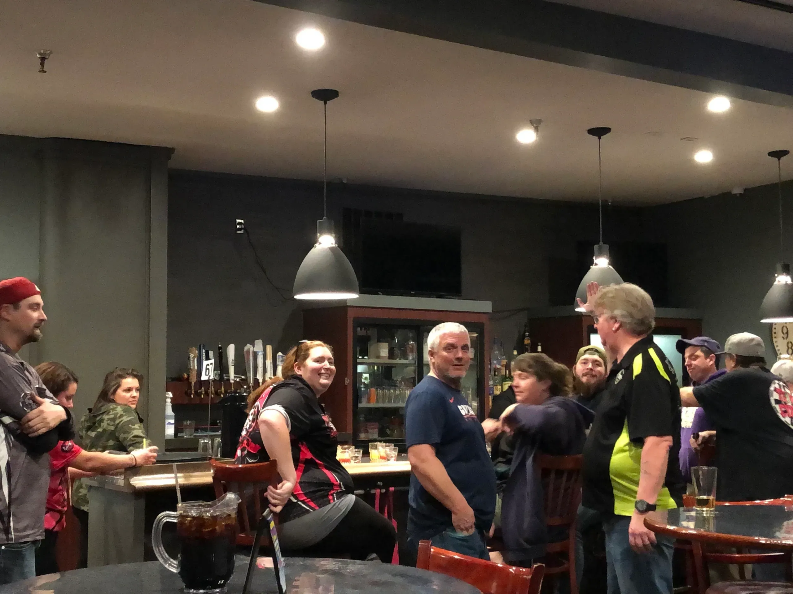Group chatting in a bar setting