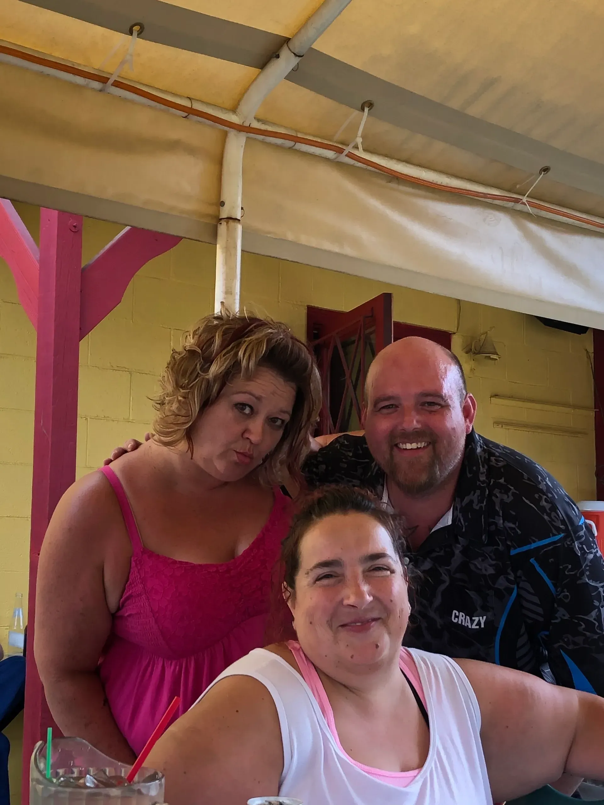 Group of three friends smiling outdoors