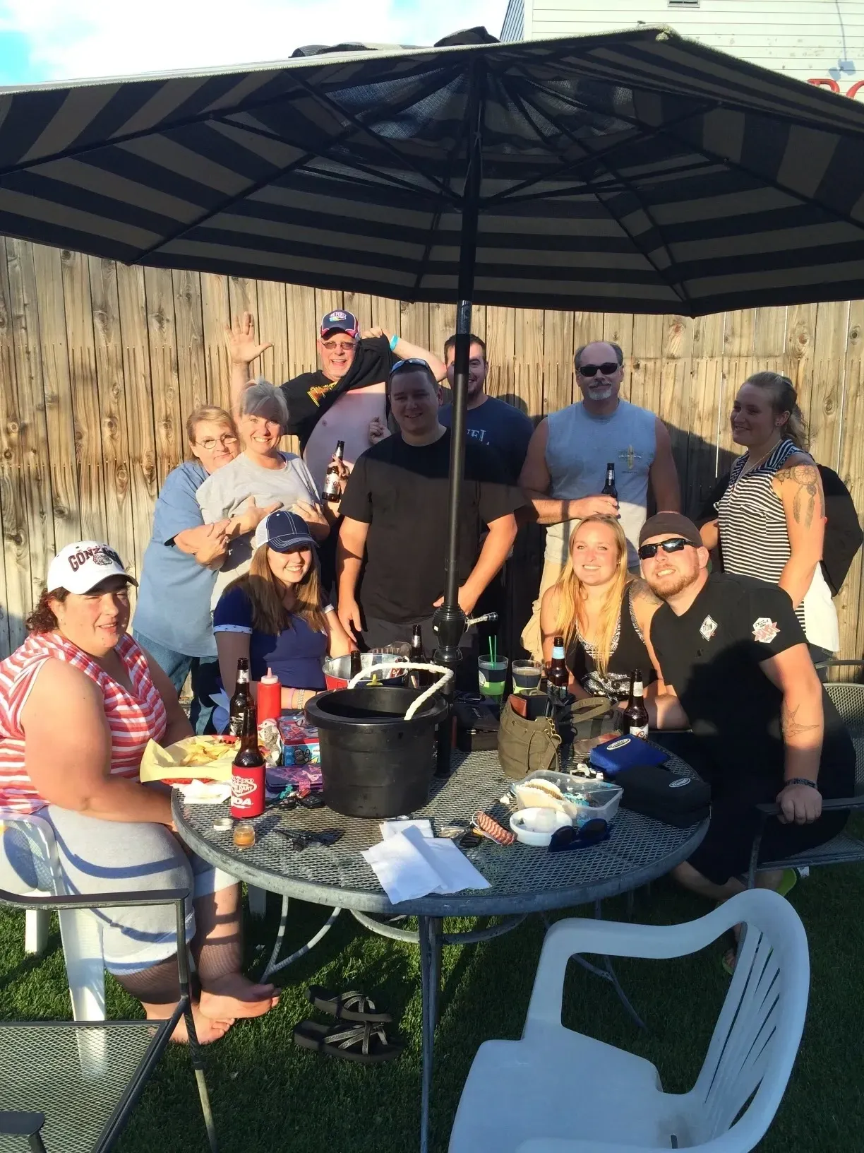 People smiling around patio table outdoors