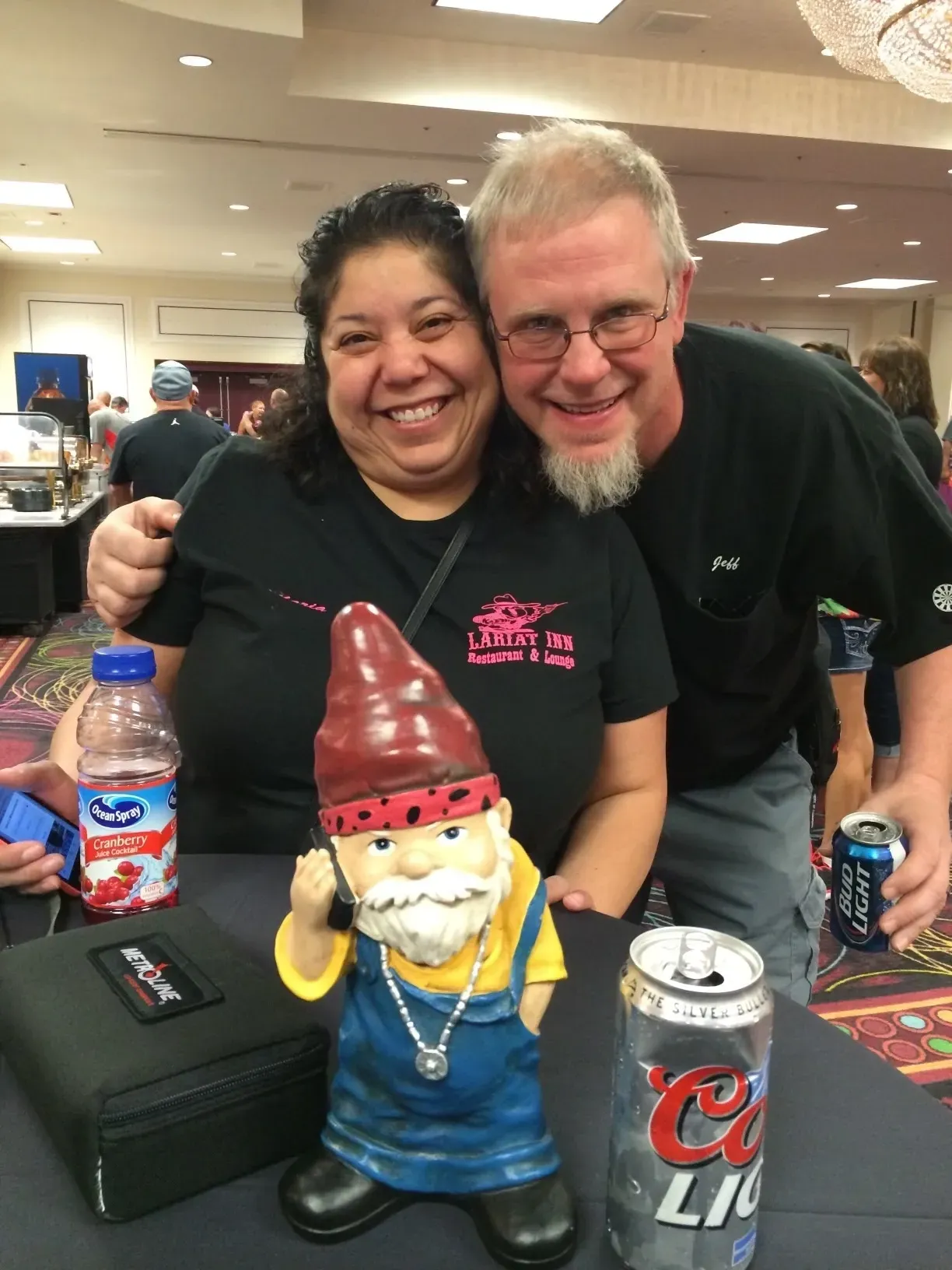 Smiling couple with garden gnome figurine