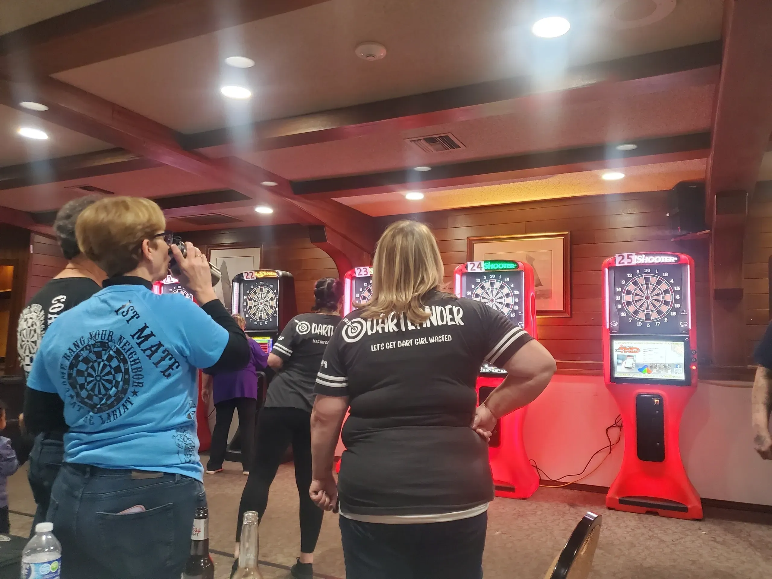 People playing darts in a bar