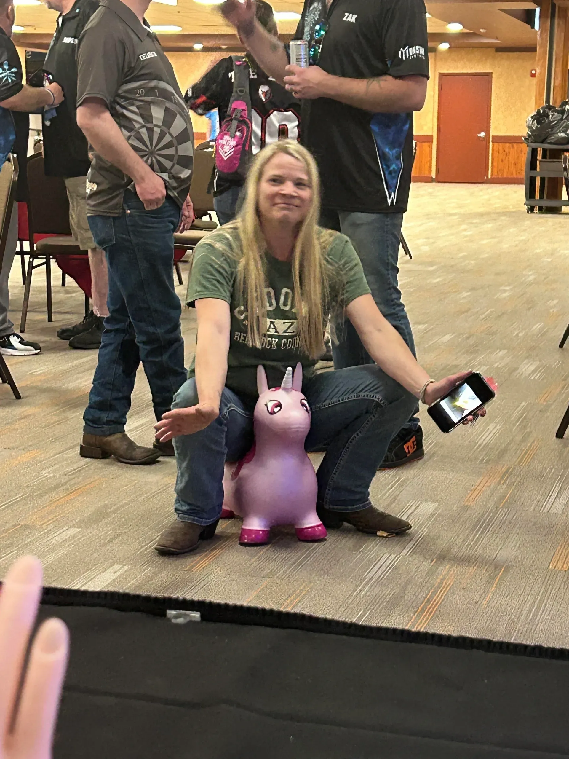 Person sitting on pink inflatable toy