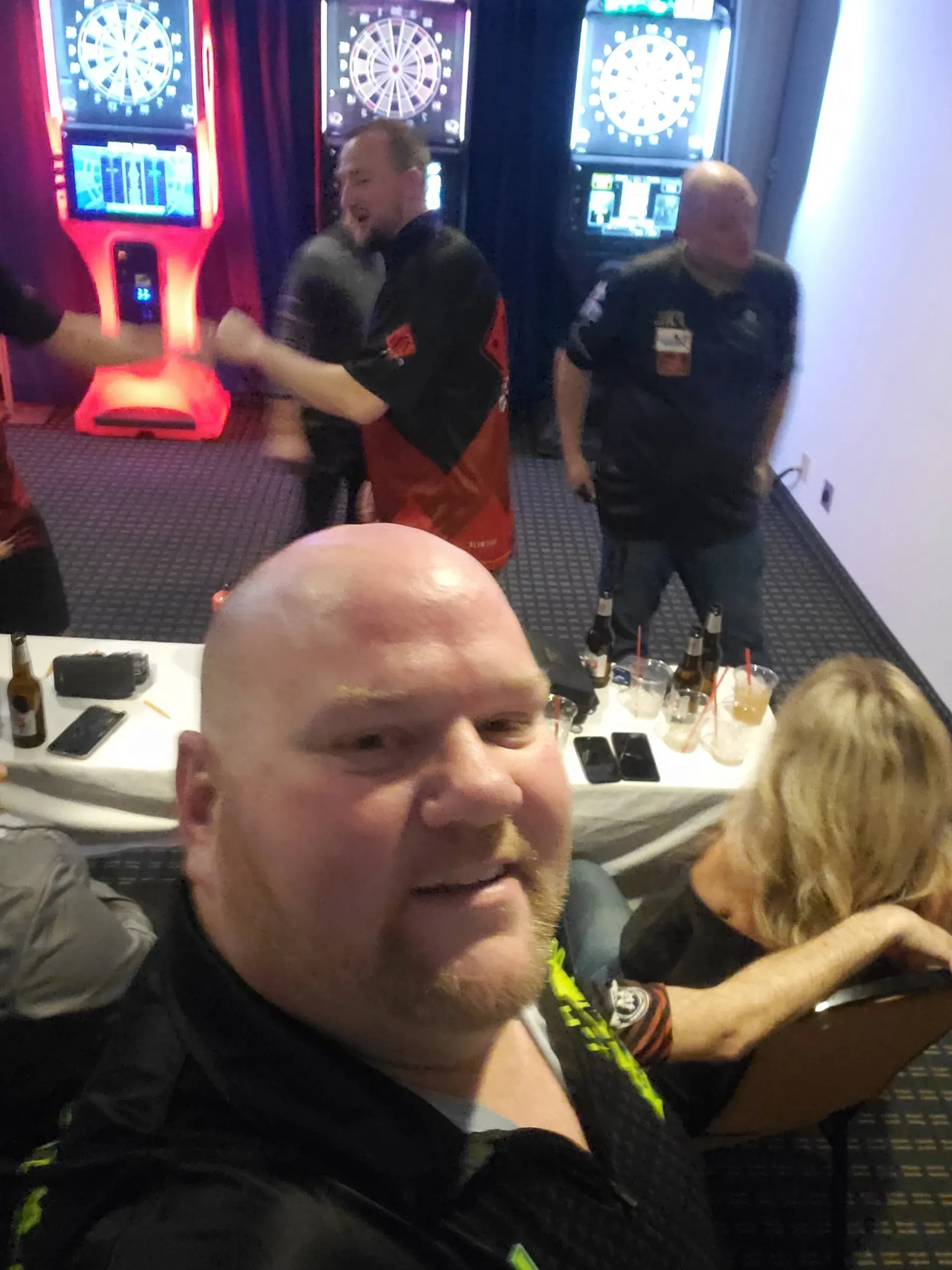 Man taking selfie at darts tournament