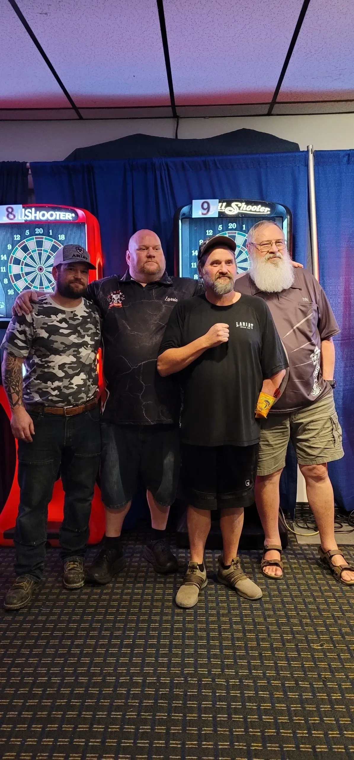 Casual gathering with dart machines in background