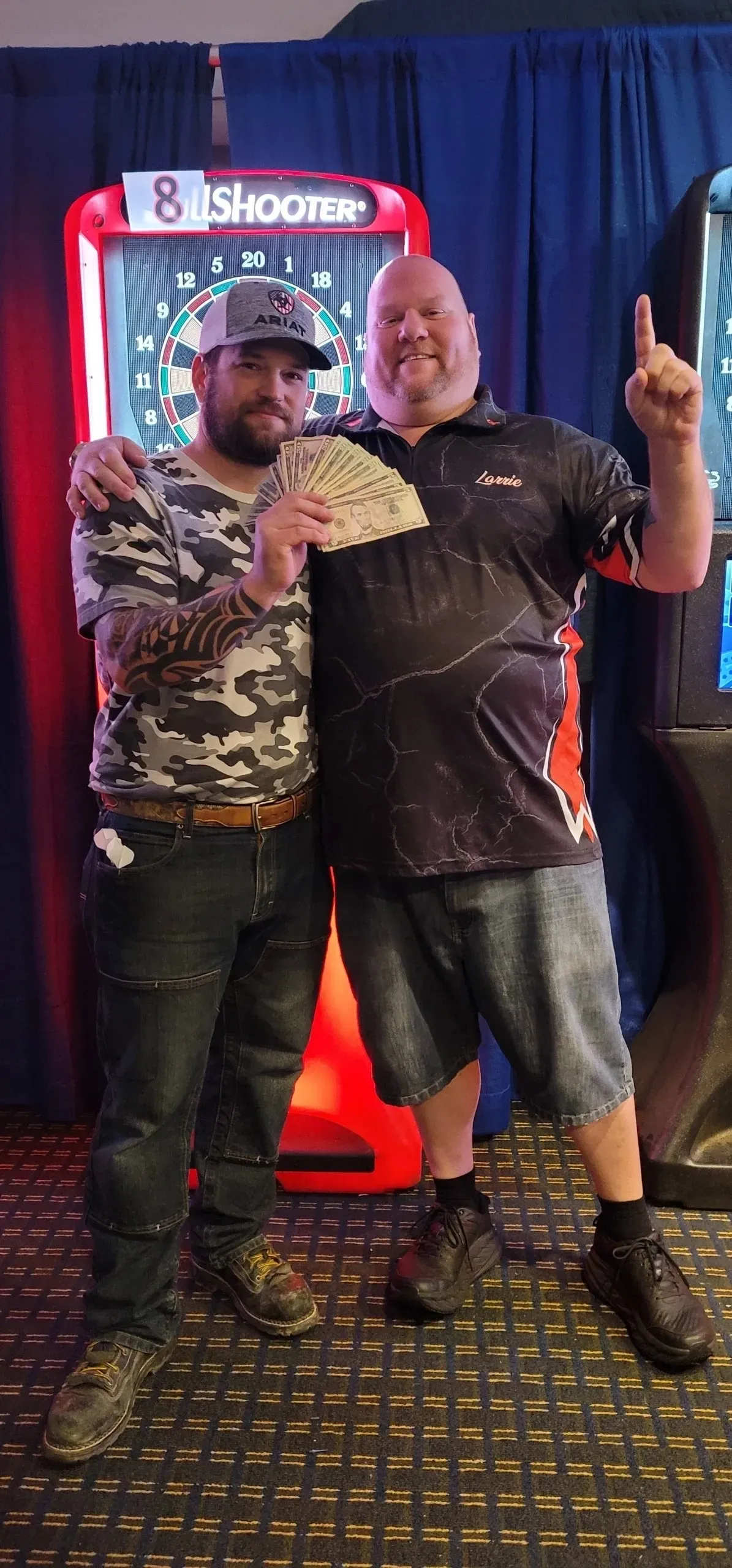 Friends posing in front of dartboard