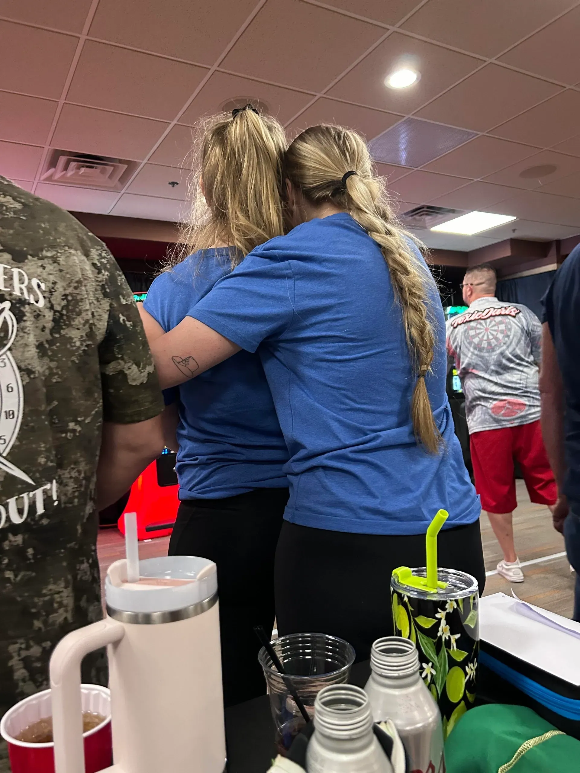 Two women hugging at a gathering